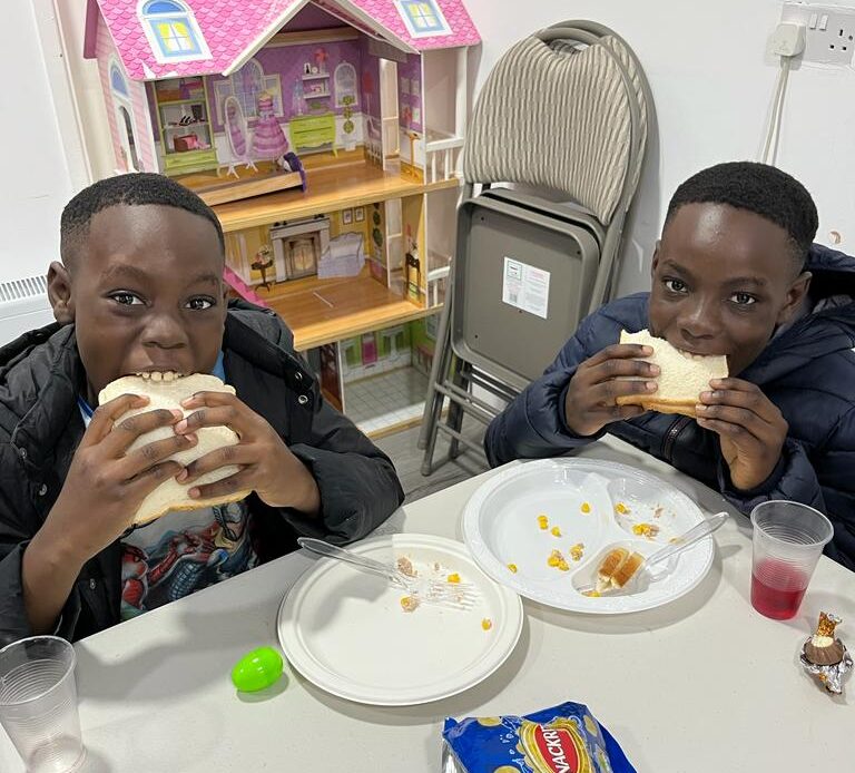 Boys eating a sandwich
