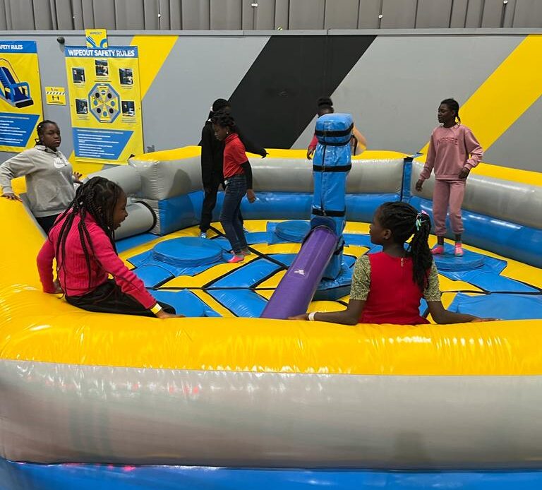 Children in inflatable spinning bar